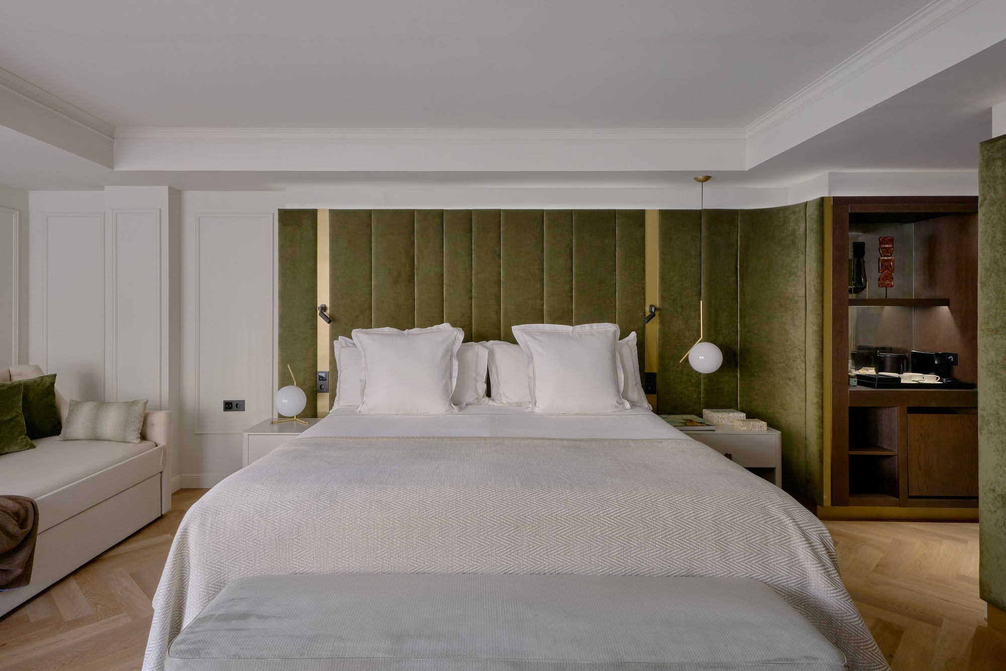 a bed with pillows and a green headboard