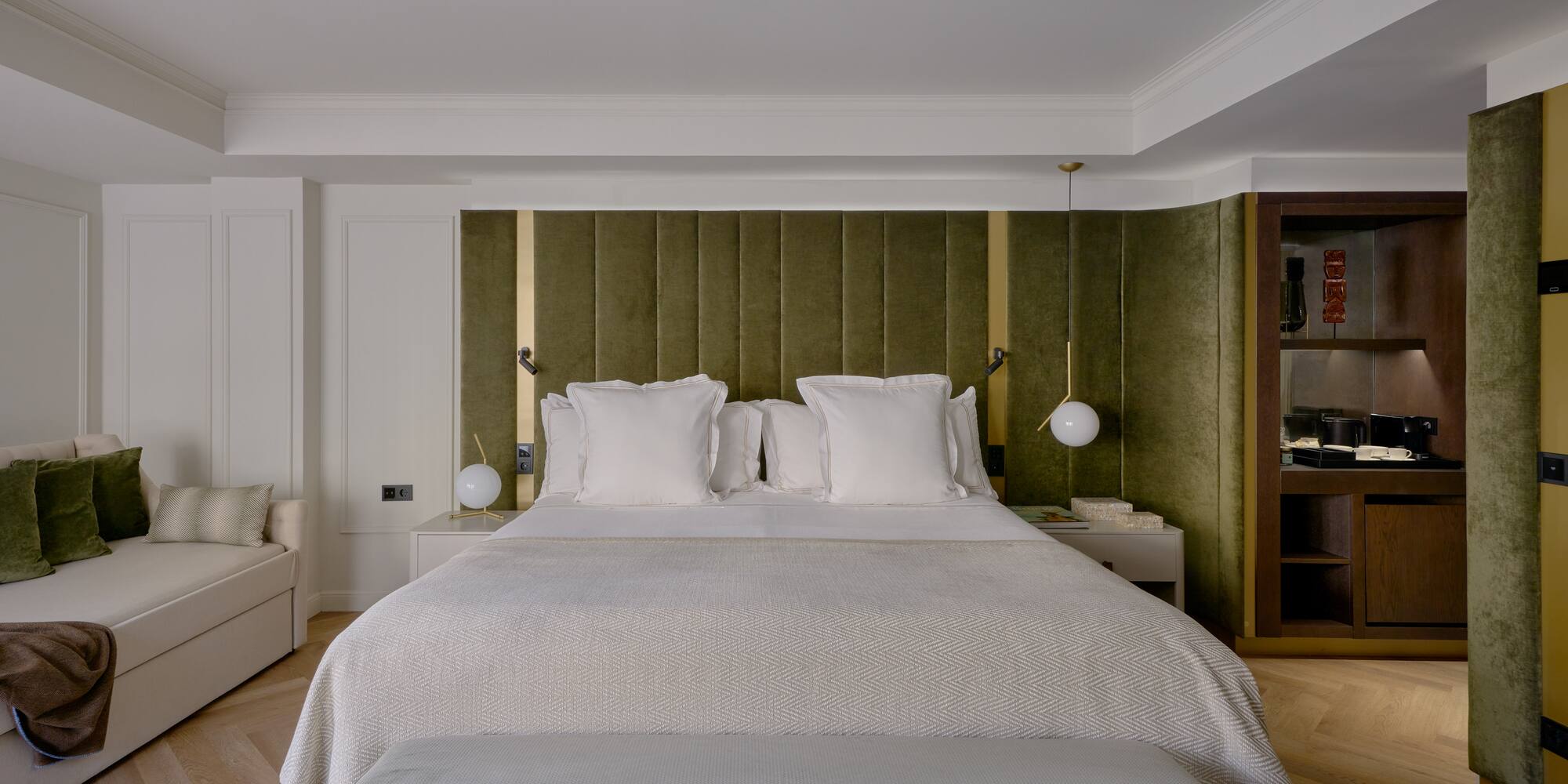 a bed with pillows and a green headboard