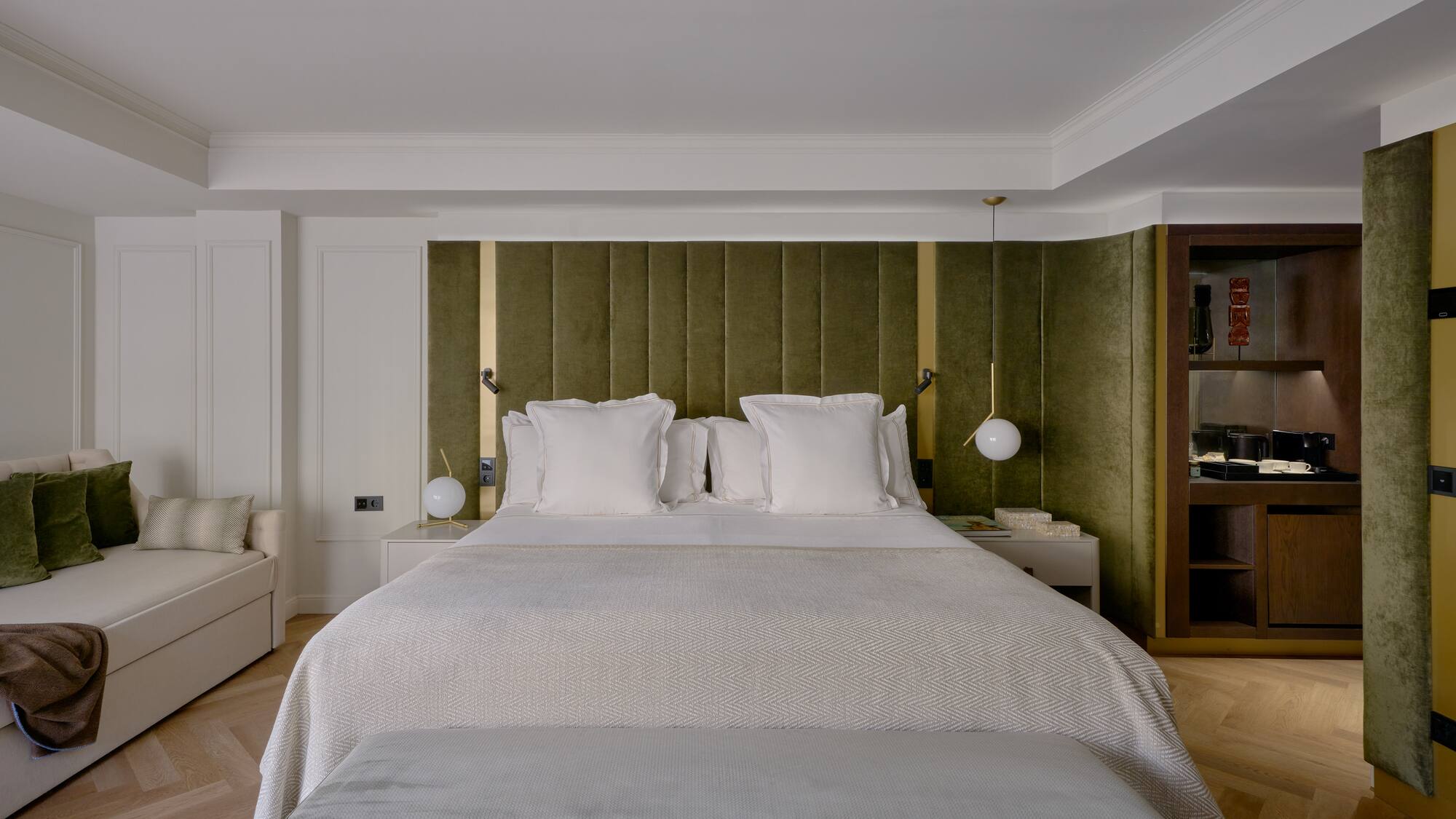 a bed with pillows and a green headboard