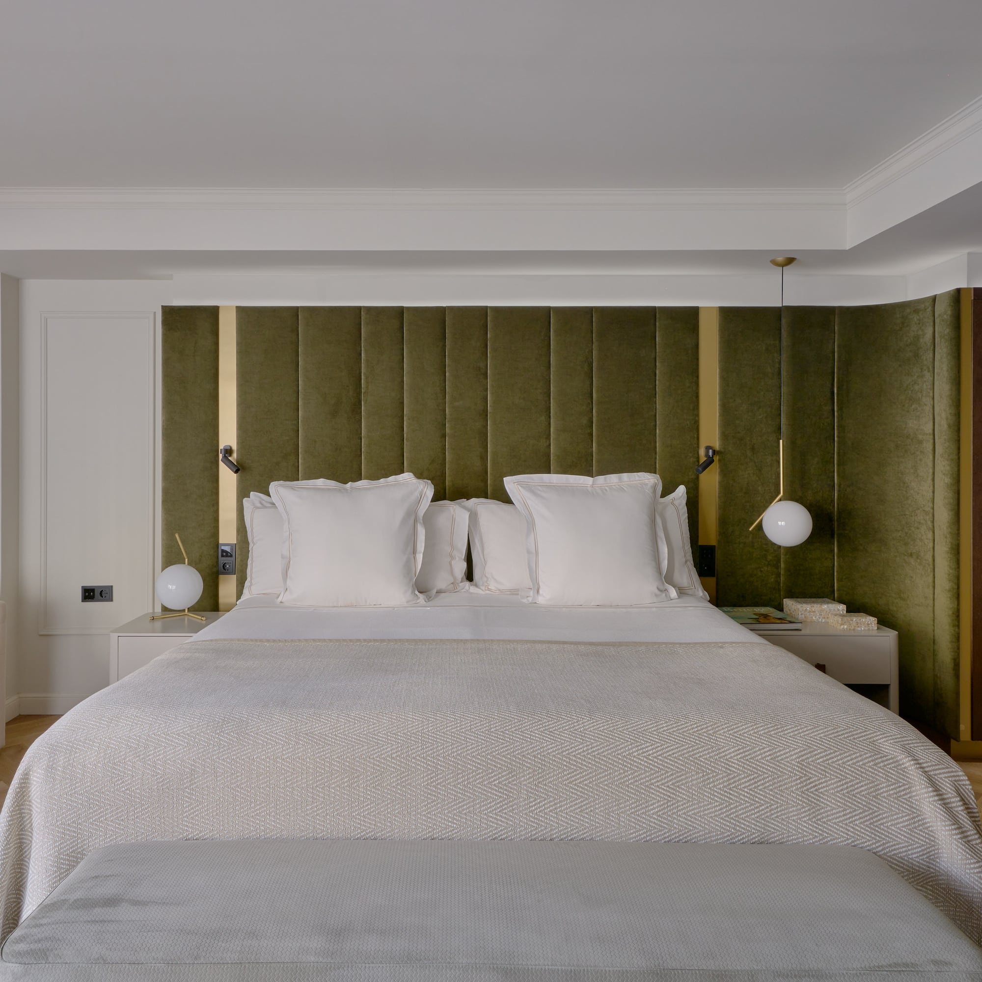 a bed with pillows and a green headboard