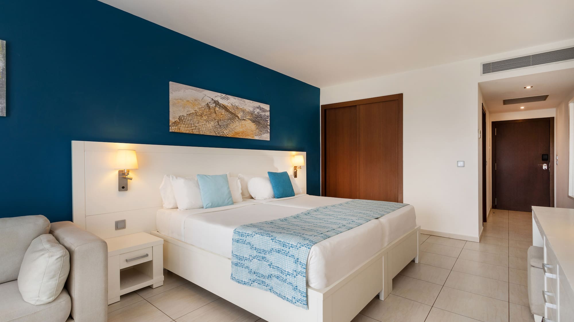 a bedroom with a bed and a blue wall