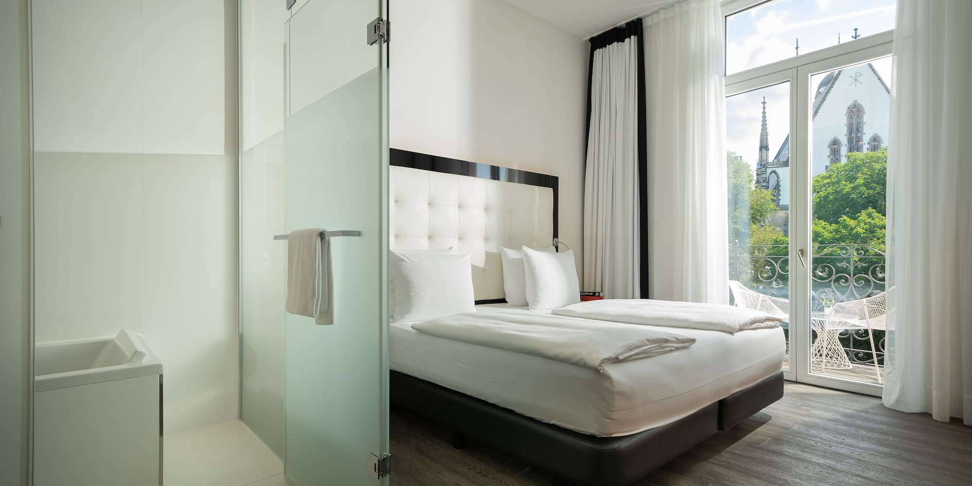 a room with a bed and glass doors