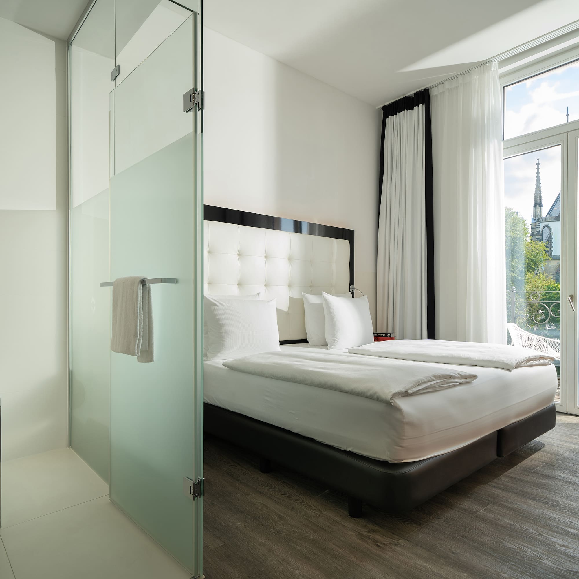 a room with a bed and glass doors