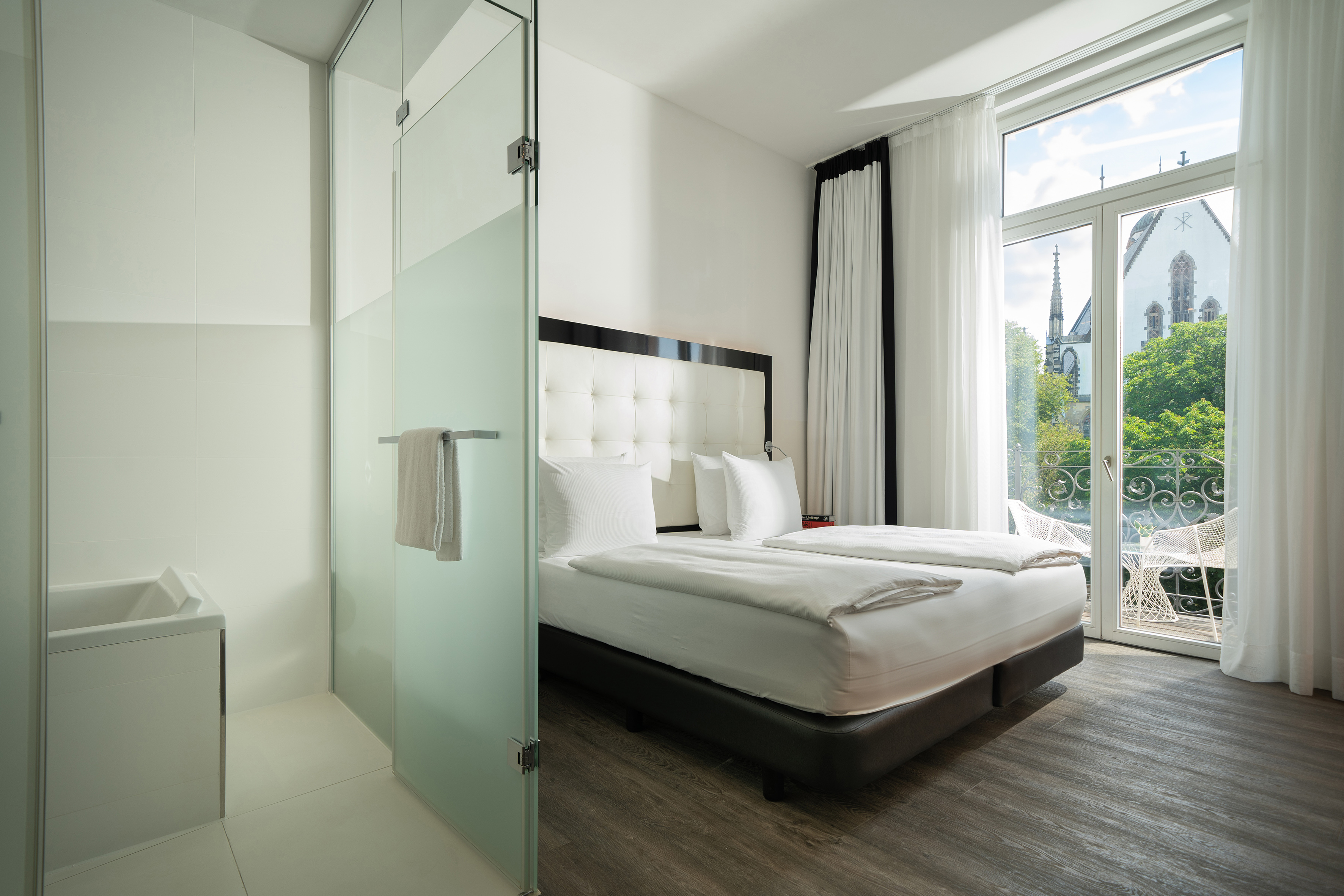 a room with a bed and glass doors