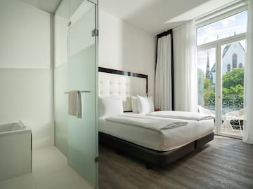 a room with a bed and glass doors