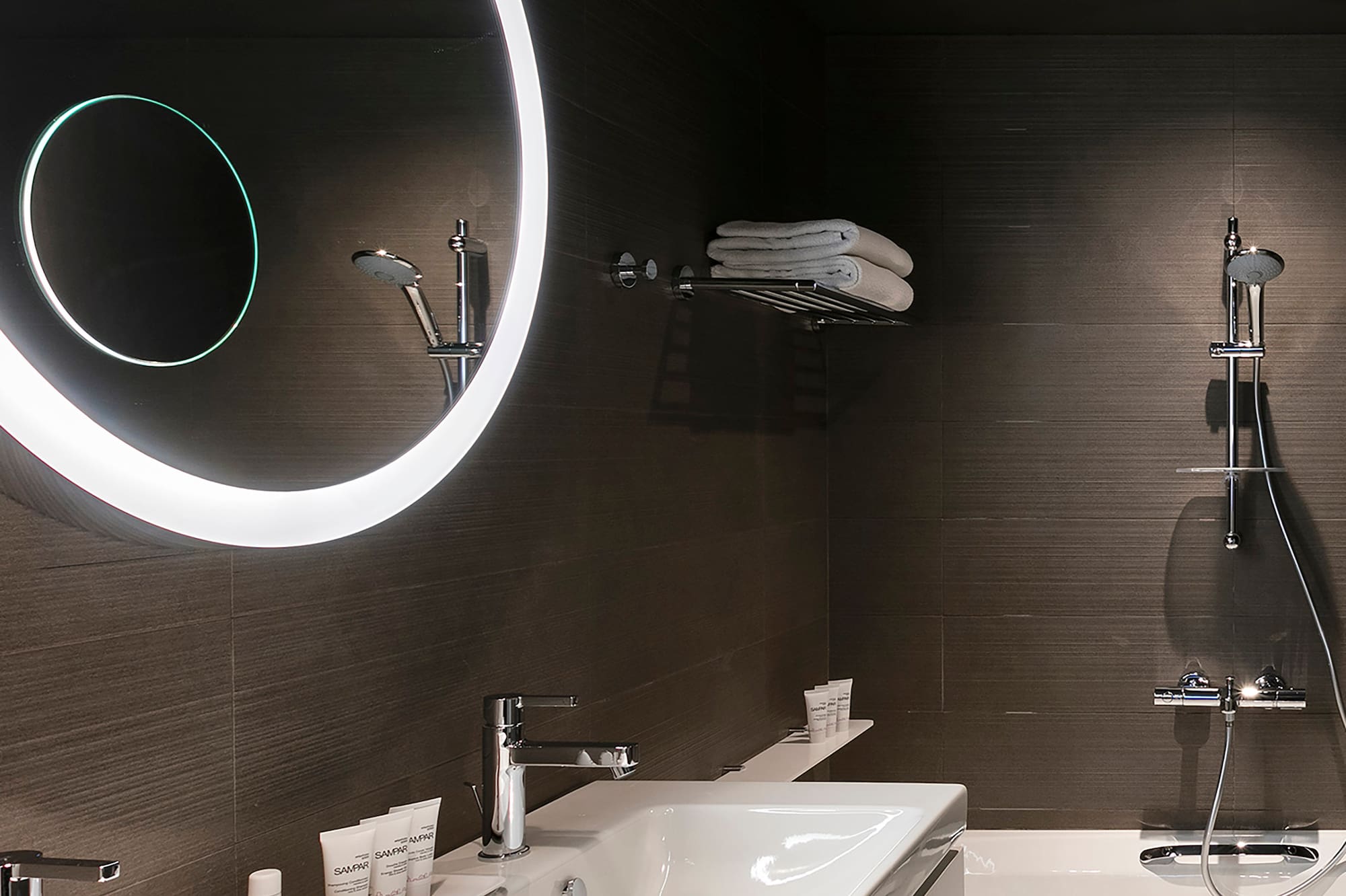 a bathroom with a round mirror