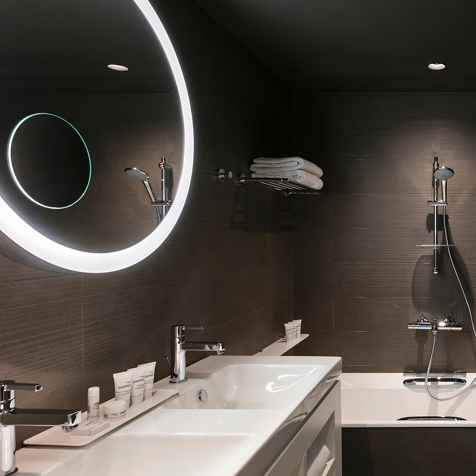 a bathroom with a round mirror