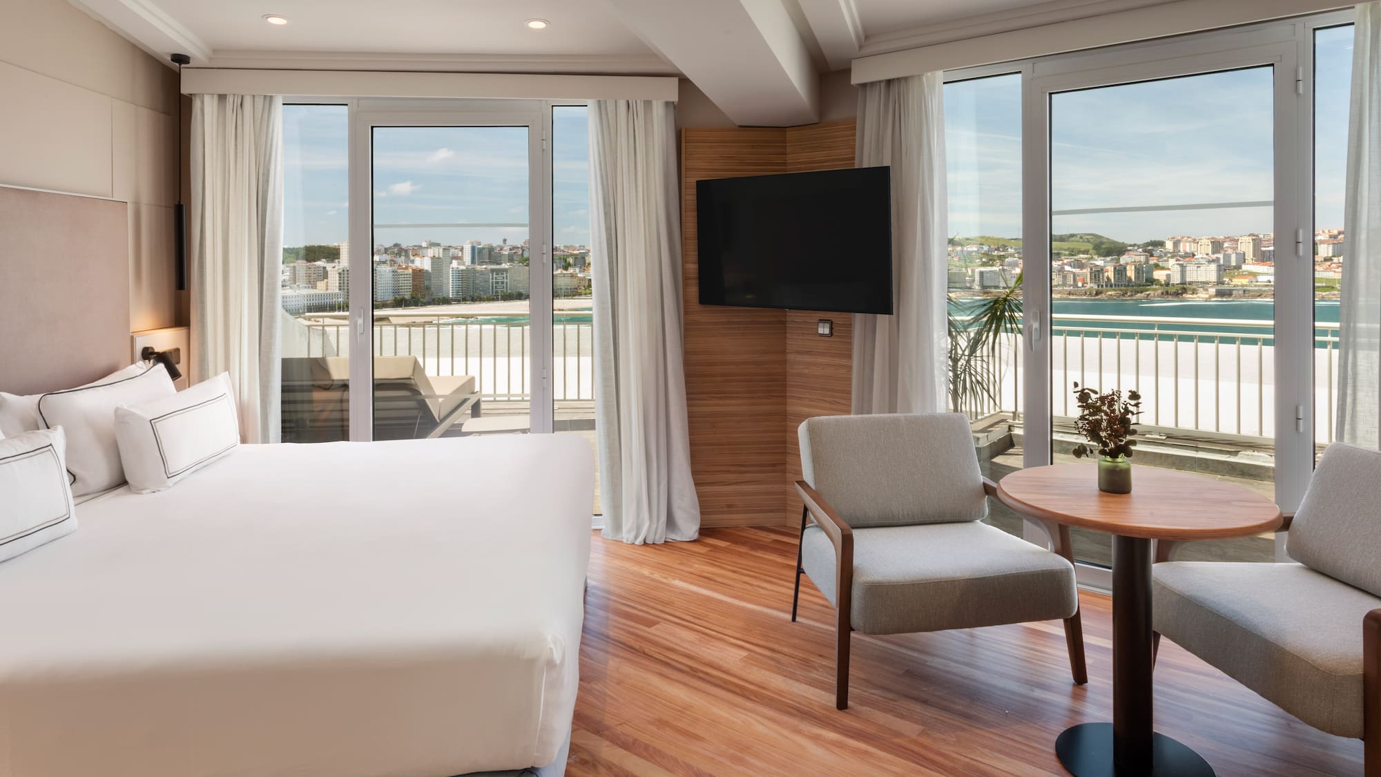 a room with a bed and a table and chairs