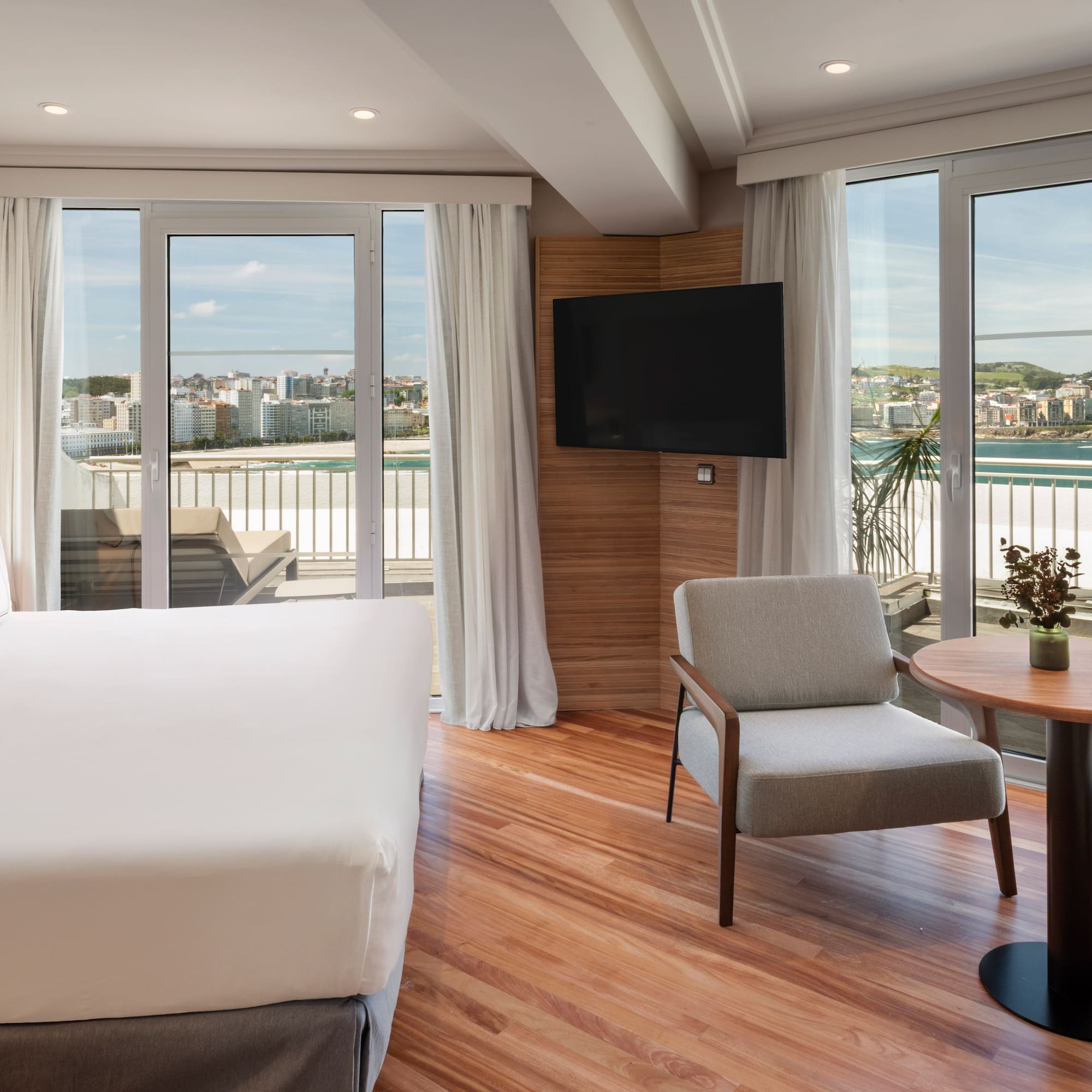 a room with a bed and a table and chairs