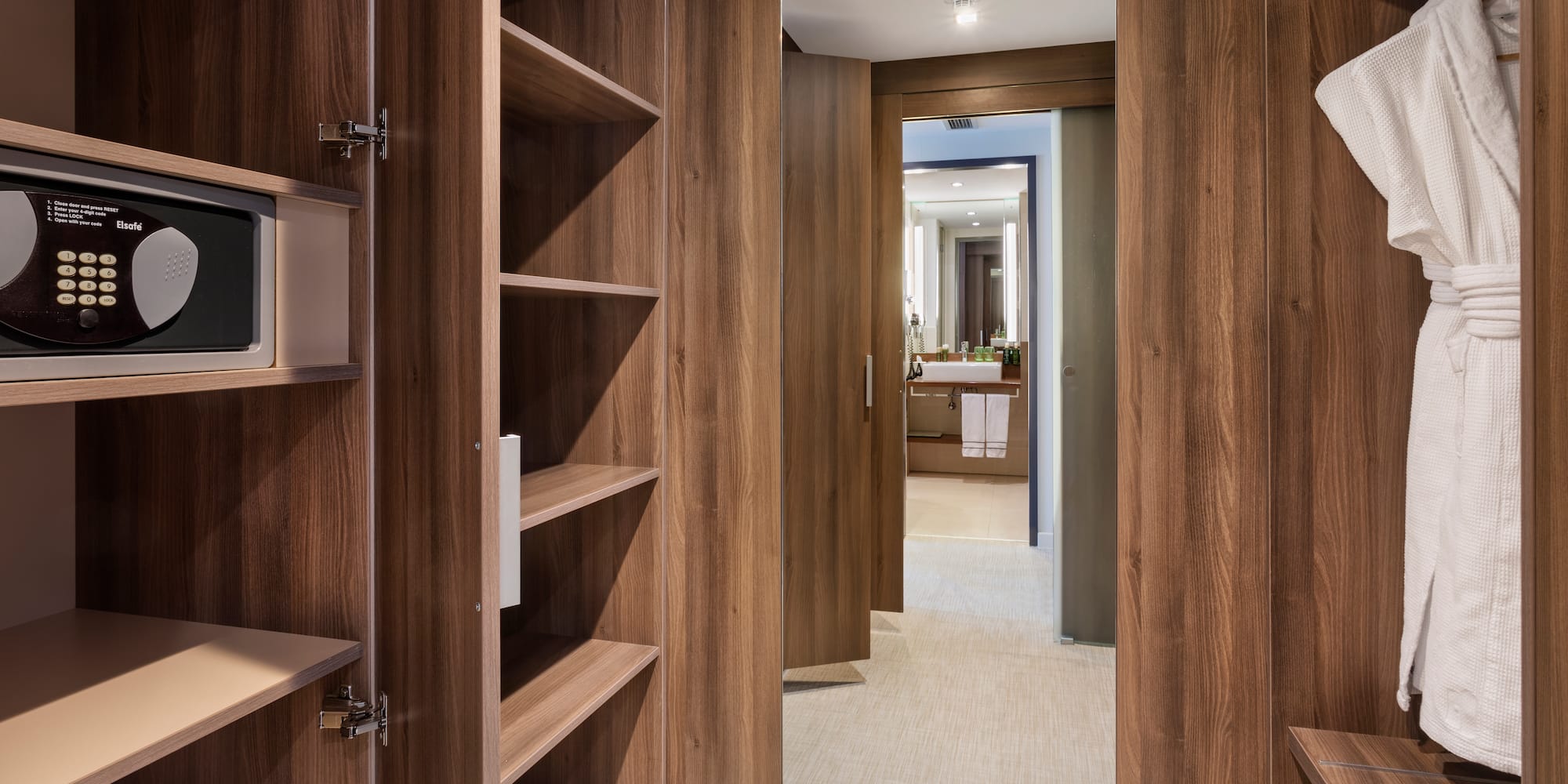 a closet with shelves and a mirror