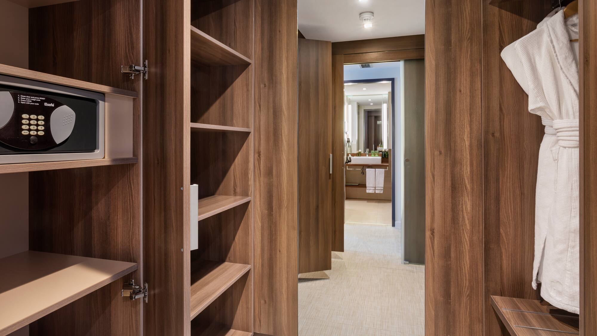 a closet with shelves and a mirror