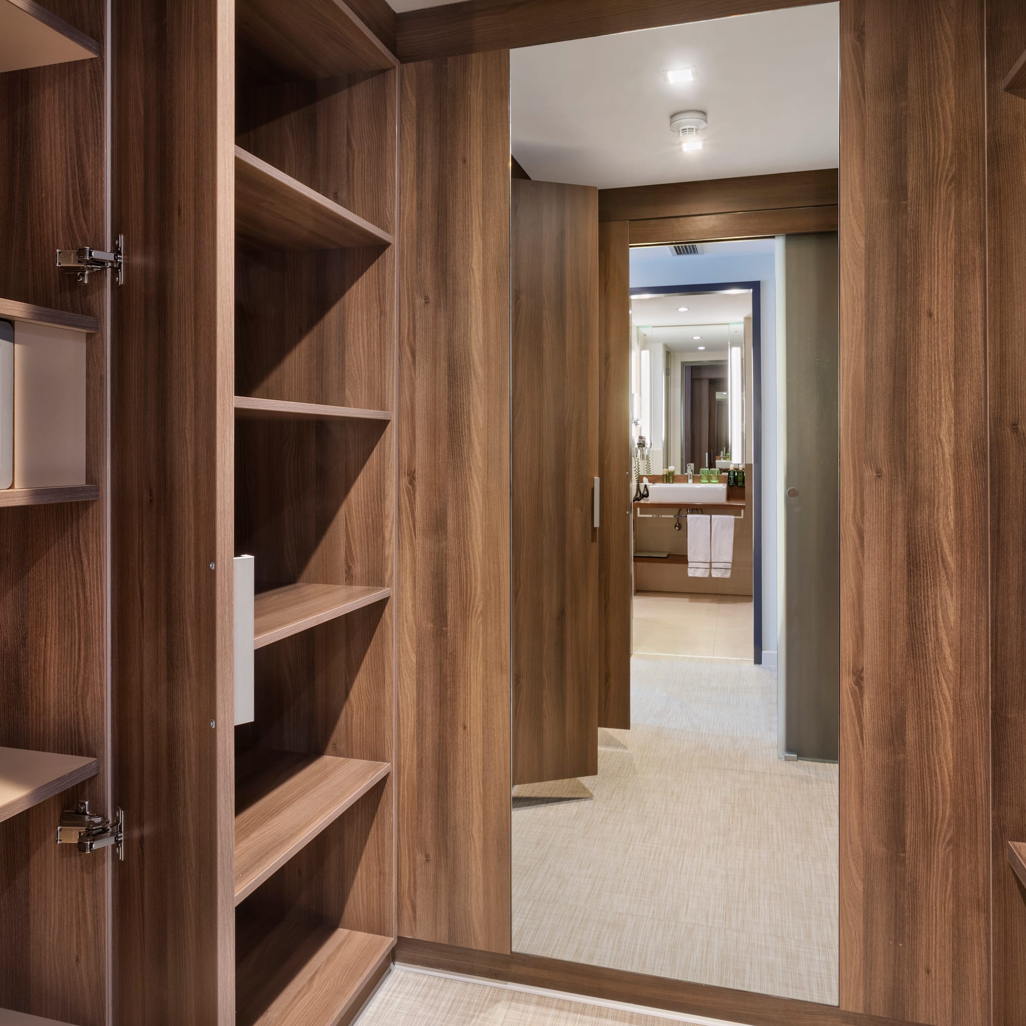 a closet with shelves and a mirror