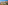 Coastal resort with orange hotels, sports courts, swimming pools, ocean, and mountains.