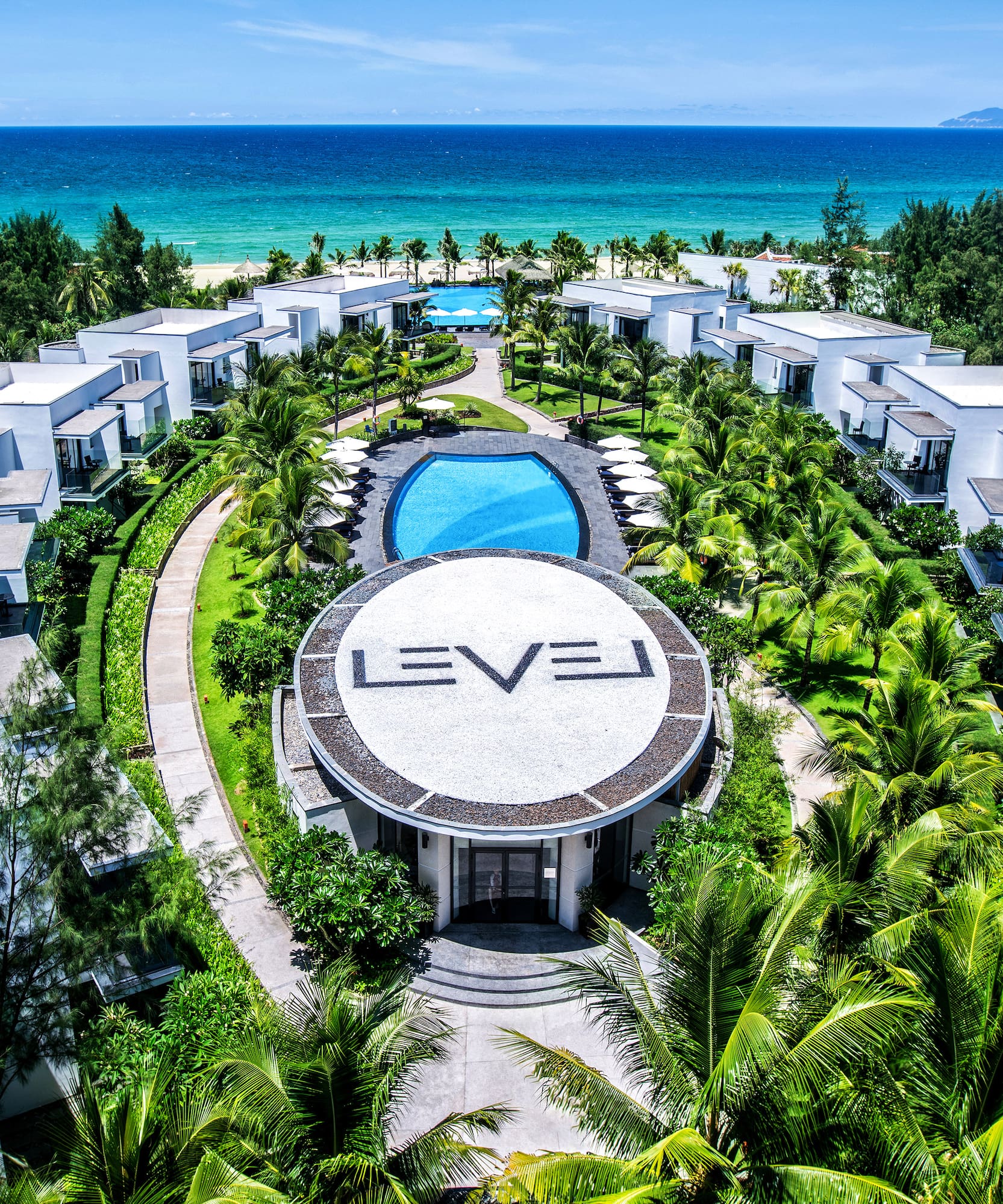 a group of buildings surrounded by trees and a pool