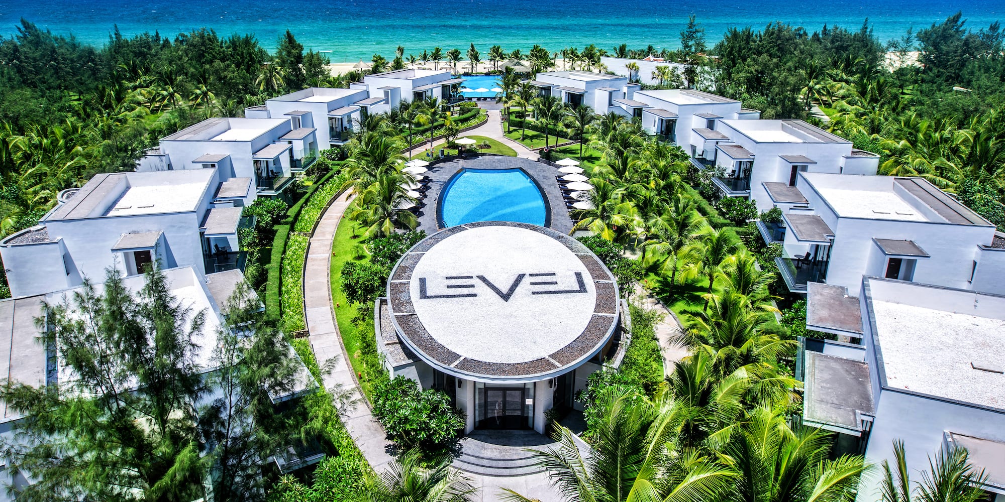 a group of buildings surrounded by trees and a pool