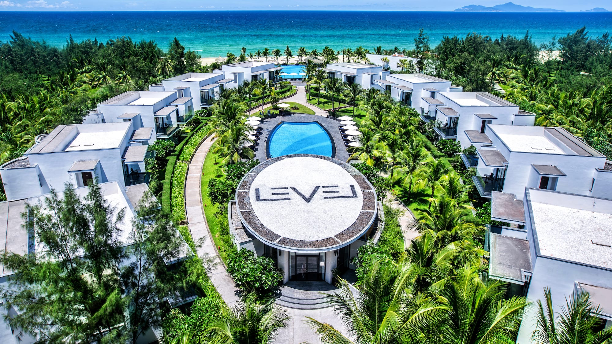 a group of buildings surrounded by trees and a pool