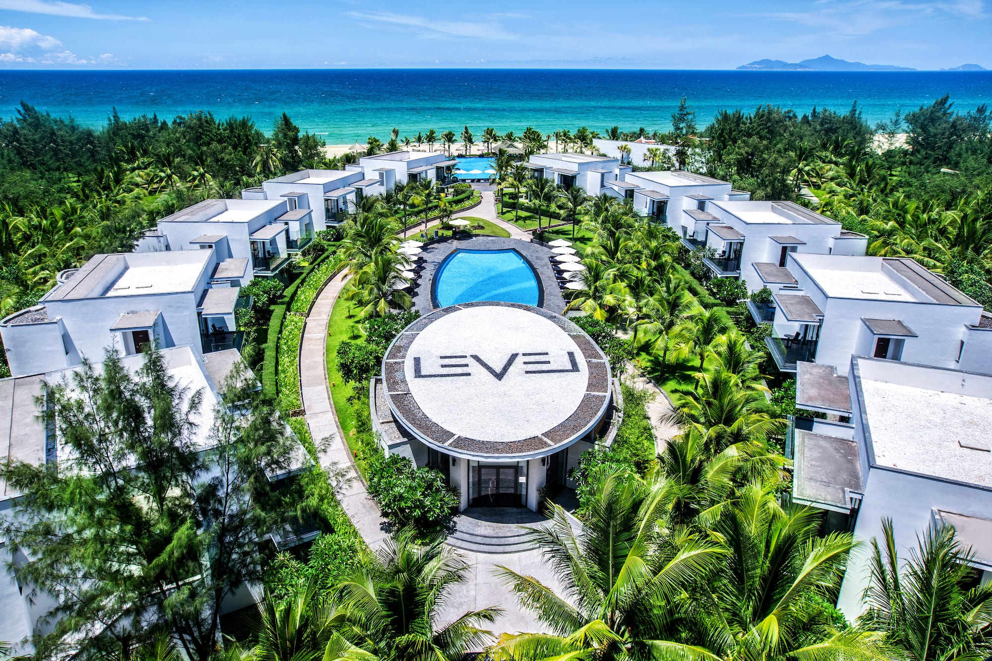 a group of buildings surrounded by trees and a pool