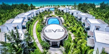 a group of buildings surrounded by trees and a pool