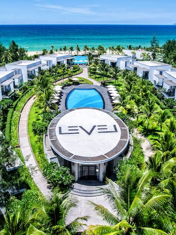 a group of buildings surrounded by trees and a pool