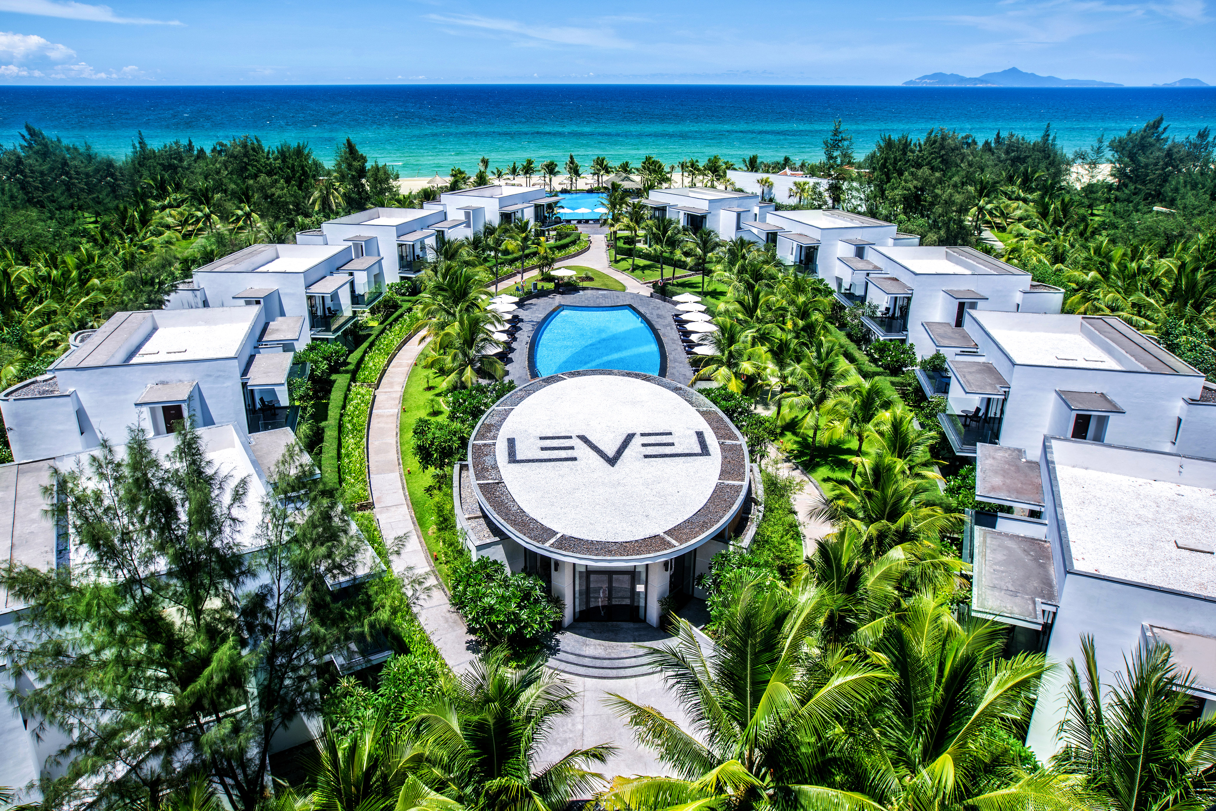 a group of buildings surrounded by trees and a pool