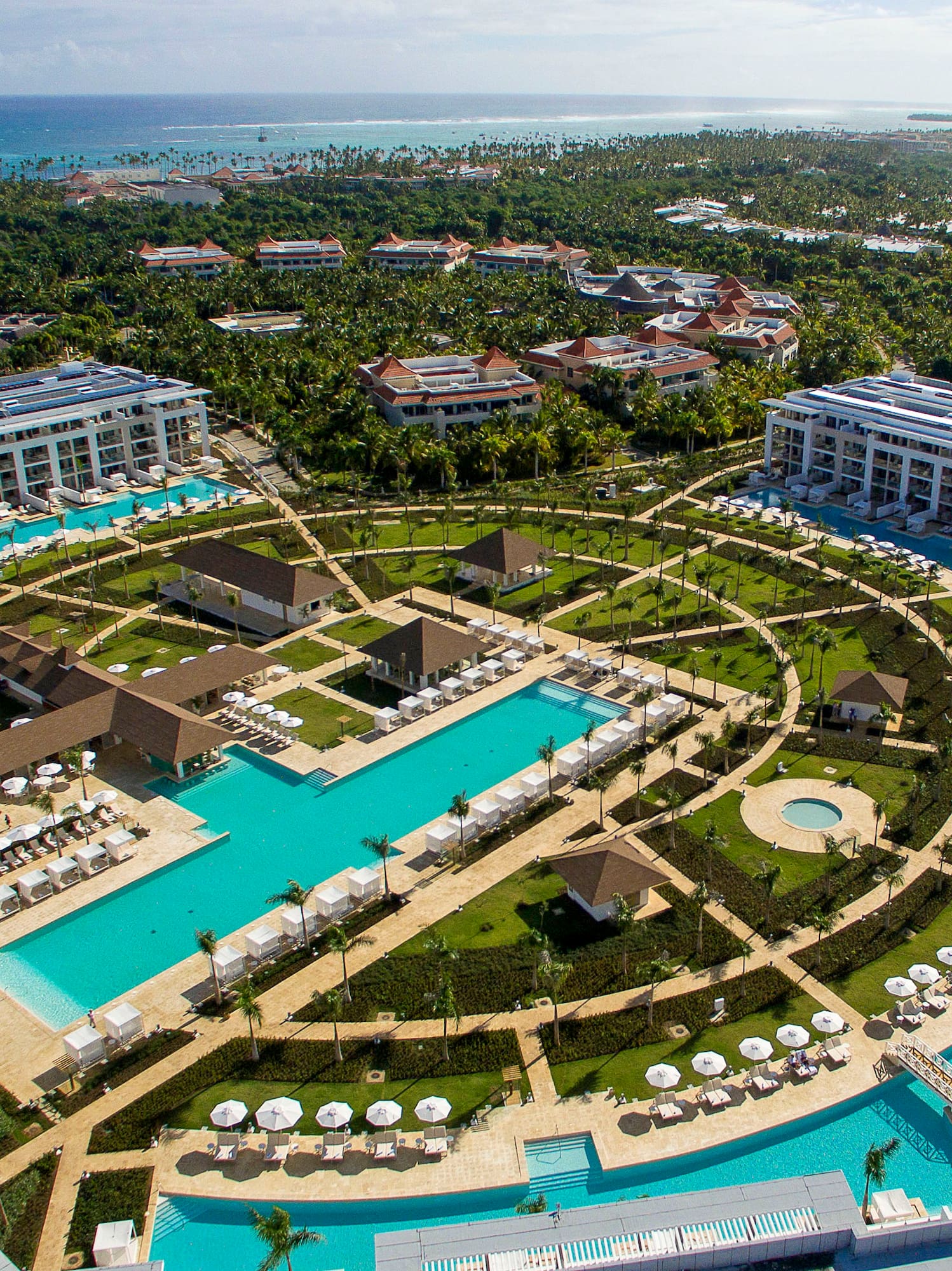 a pool area with buildings and trees