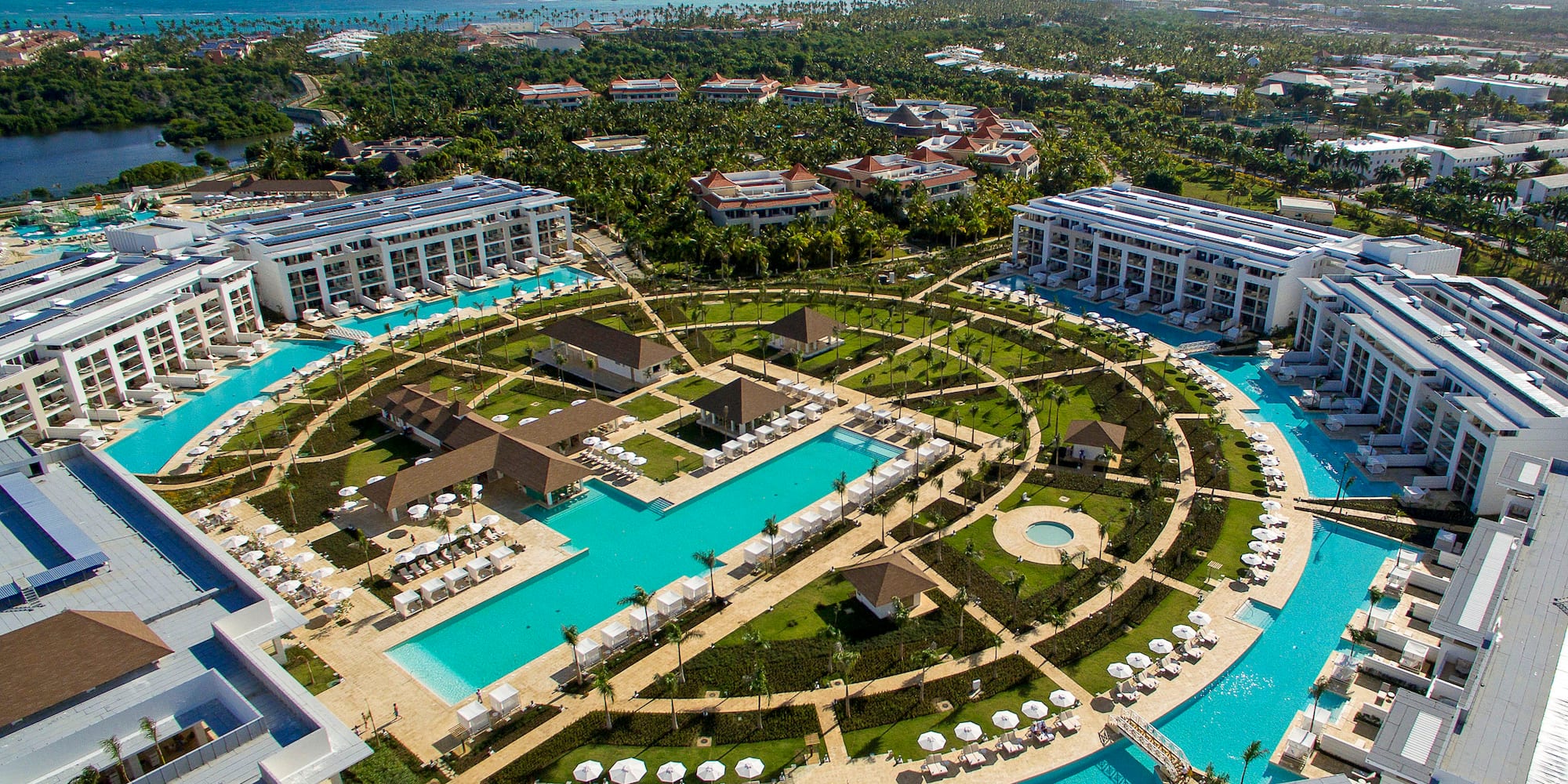 a pool area with buildings and trees