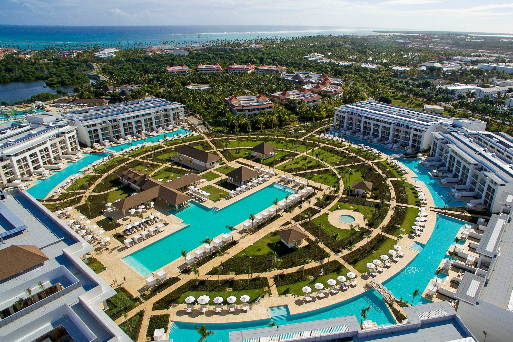 a pool area with buildings and trees