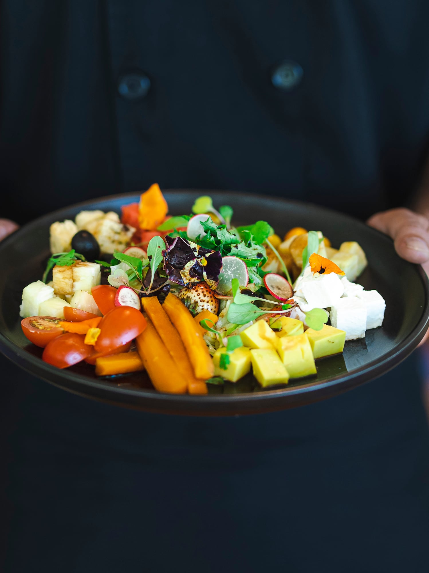 a person holding a plate of food