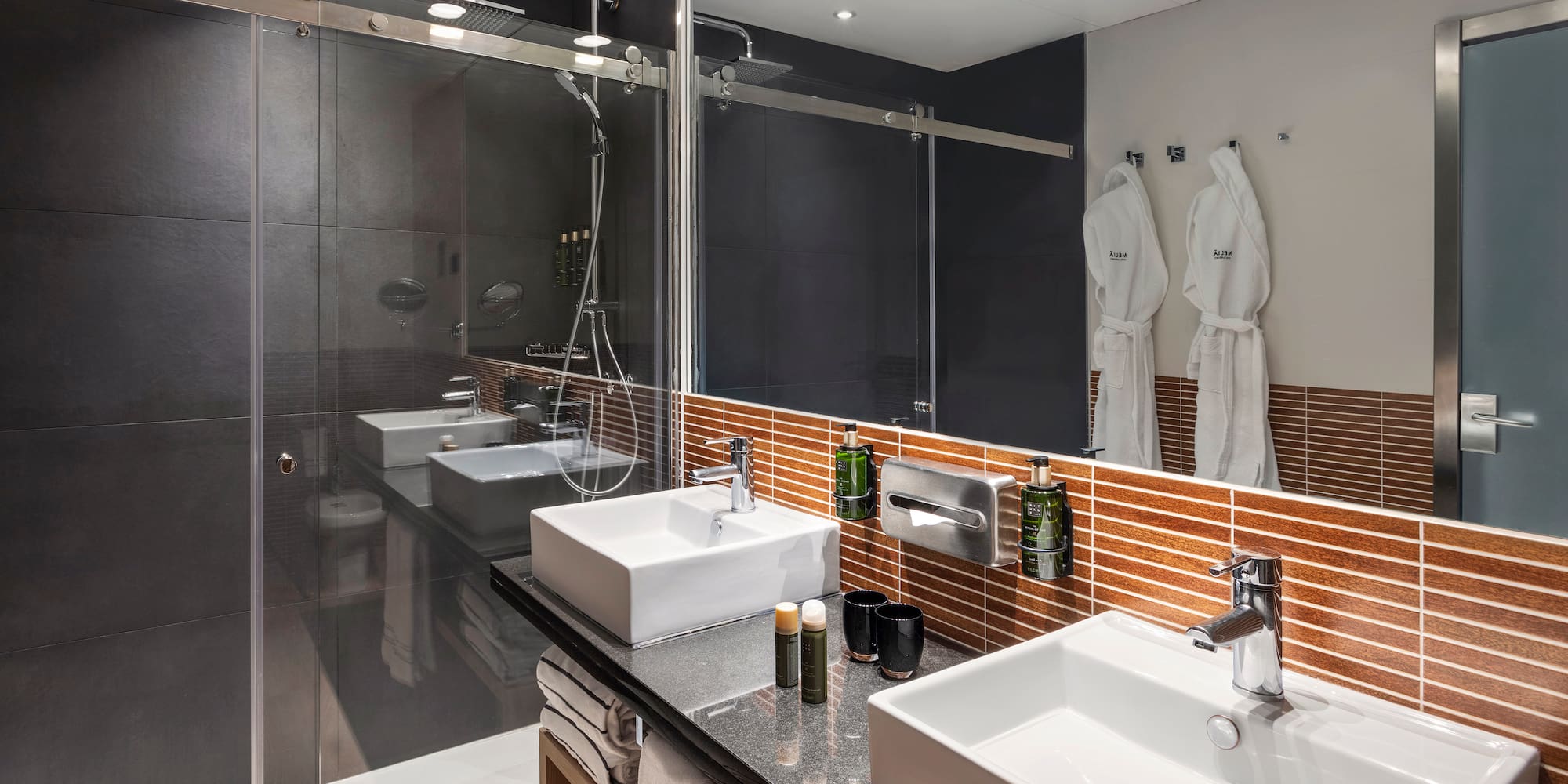 a bathroom with a shower and two sinks