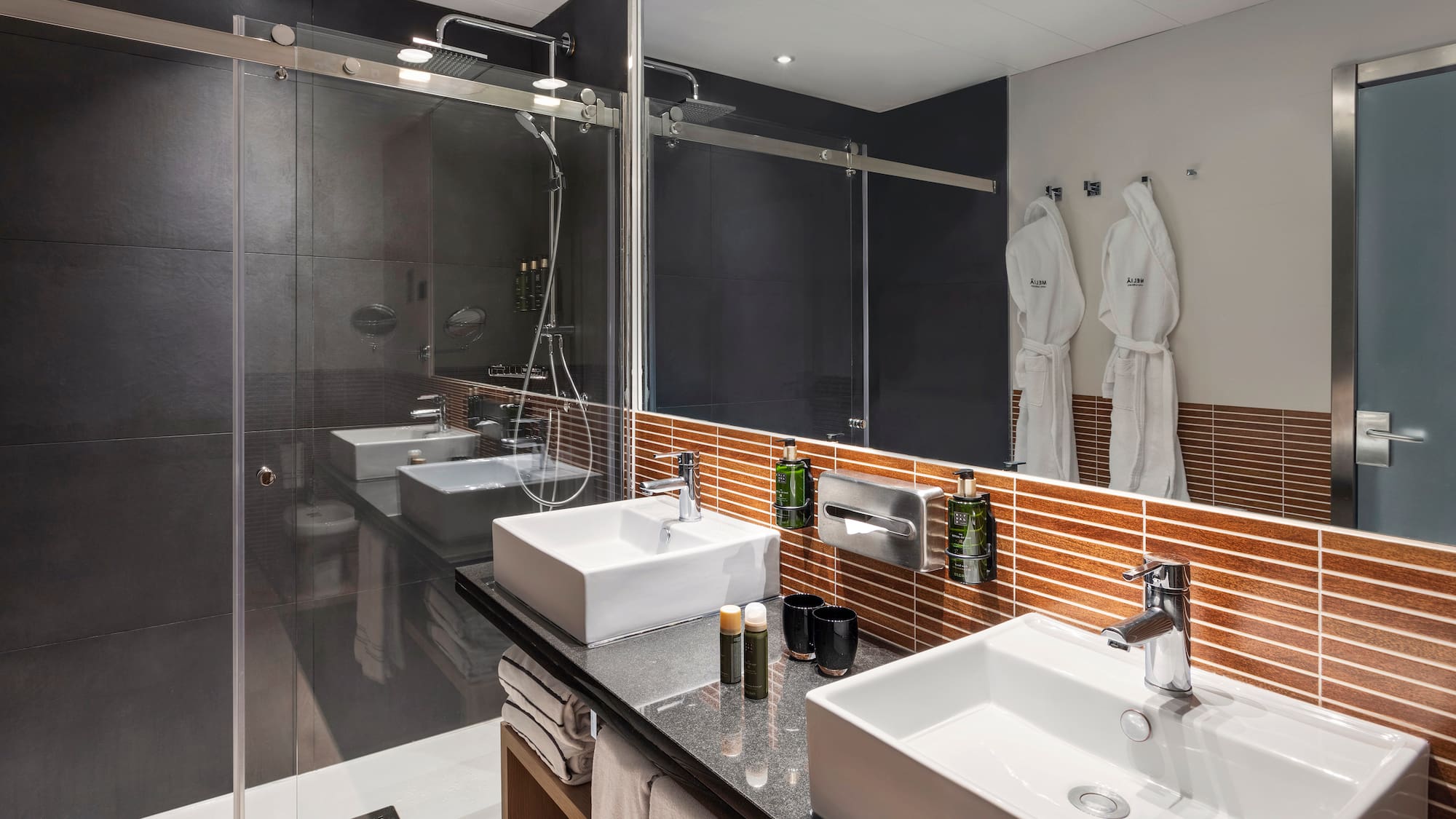 a bathroom with a shower and two sinks