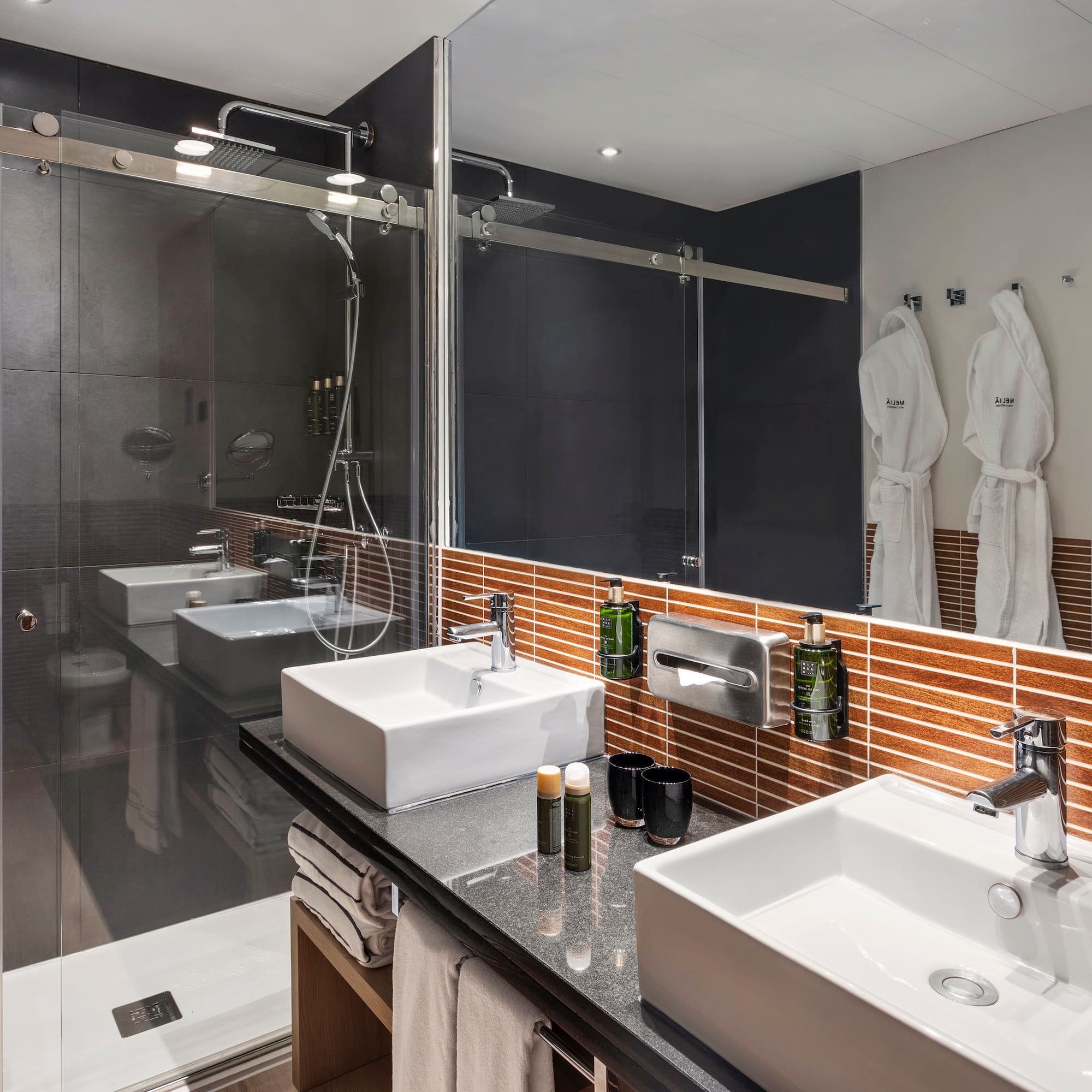 a bathroom with a shower and two sinks