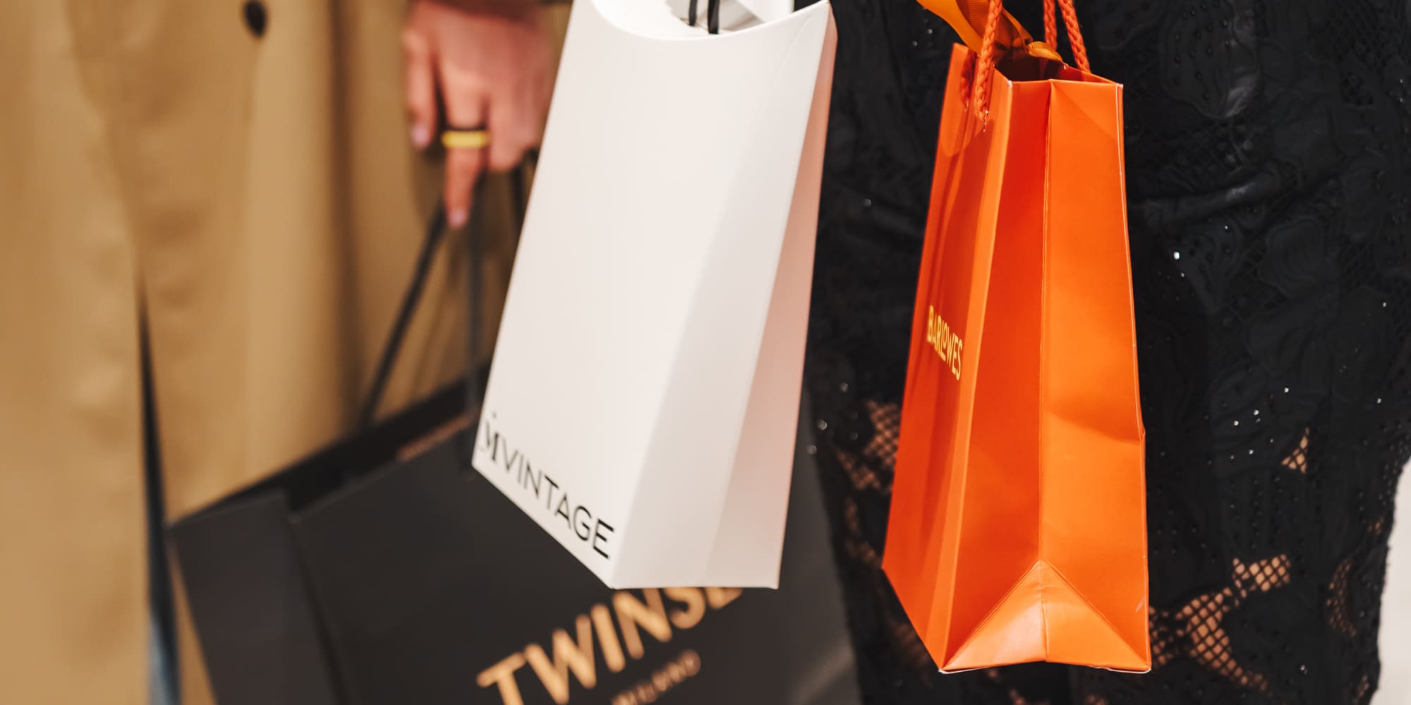 Shoppers with MVINTAGE, TWINS Milano, BARDOWES luxury shopping bags.
