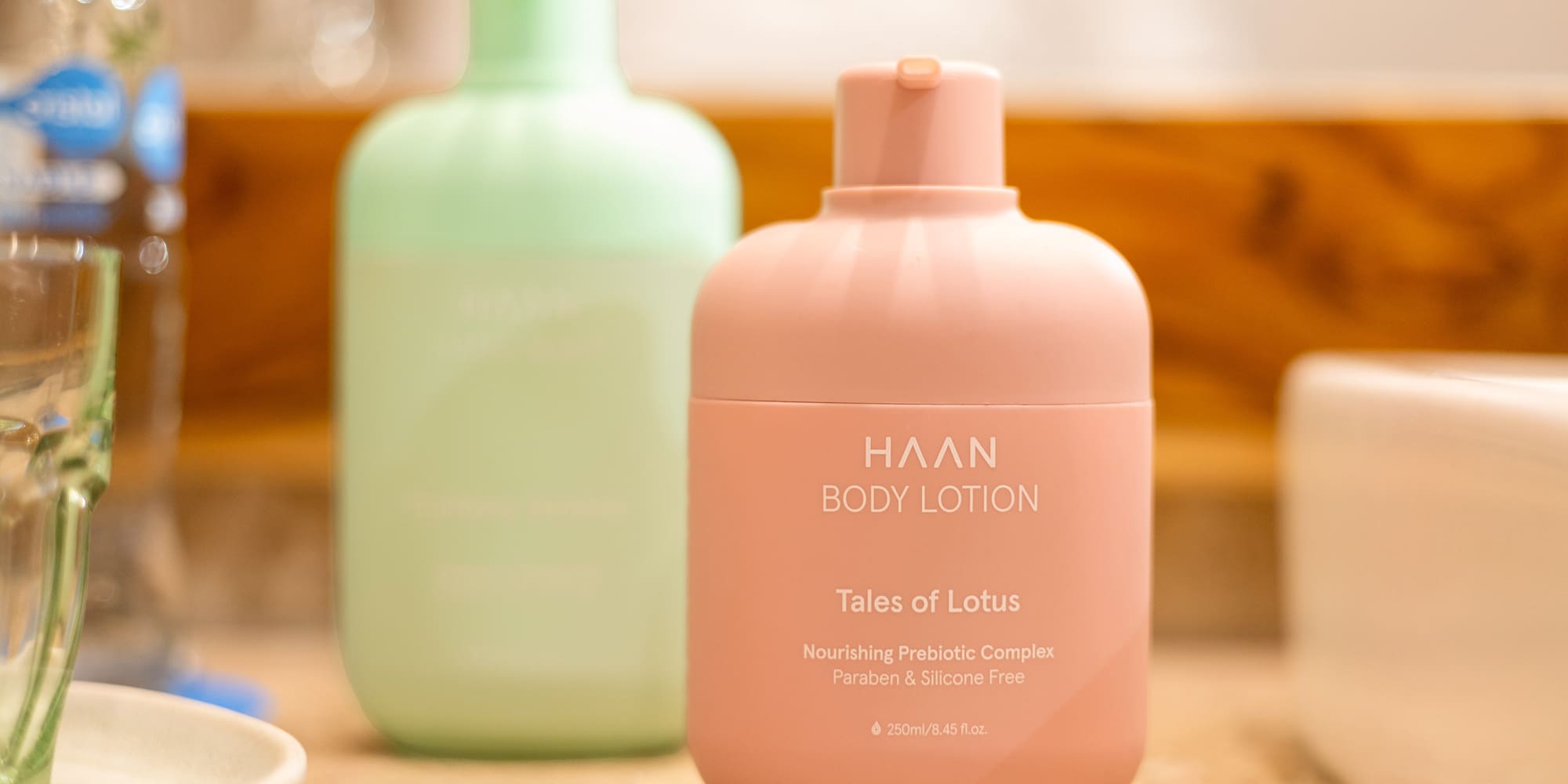 HAAN body lotion bottle in pink with Tales of Lotus scent on a bathroom counter. - Zel Room Vistas Jardín - Zel Cozumel, Cozumel