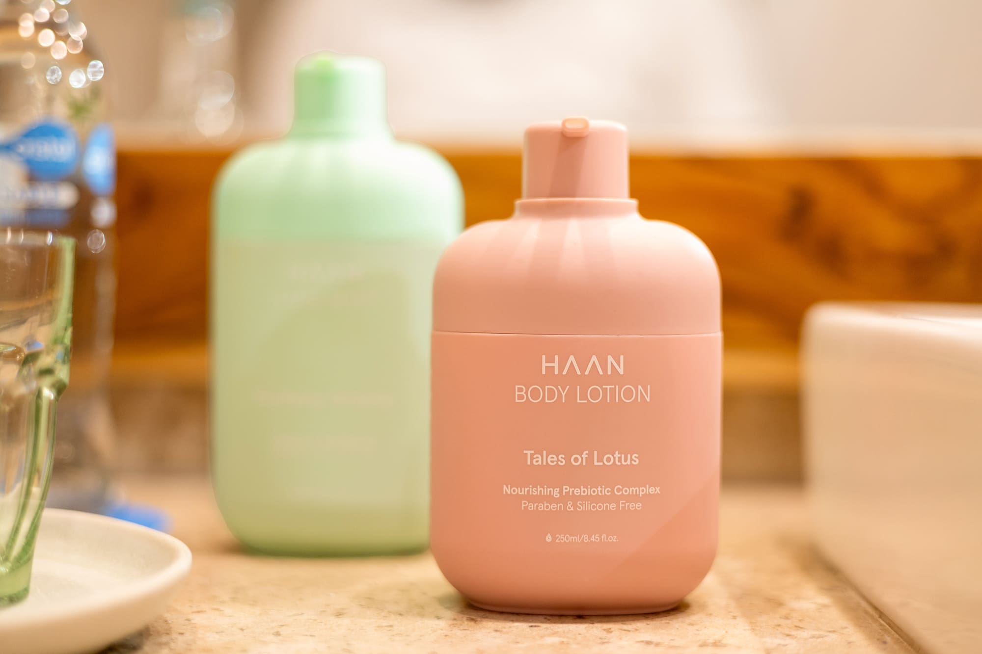 HAAN body lotion bottle in pink with Tales of Lotus scent on a bathroom counter. - Zel Room Vistas Jardín - Zel Cozumel, Cozumel