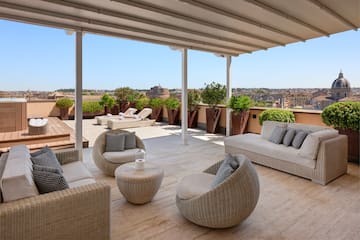 a patio with chairs and a table