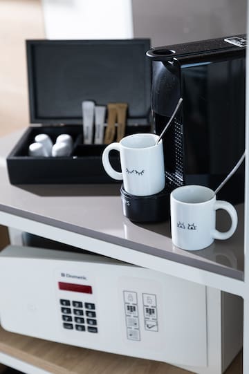 a coffee machine and mugs on a table