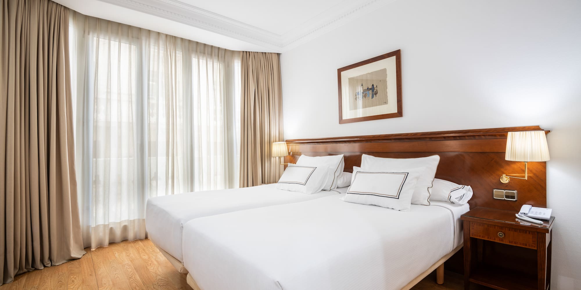 a room with two beds and a lamp