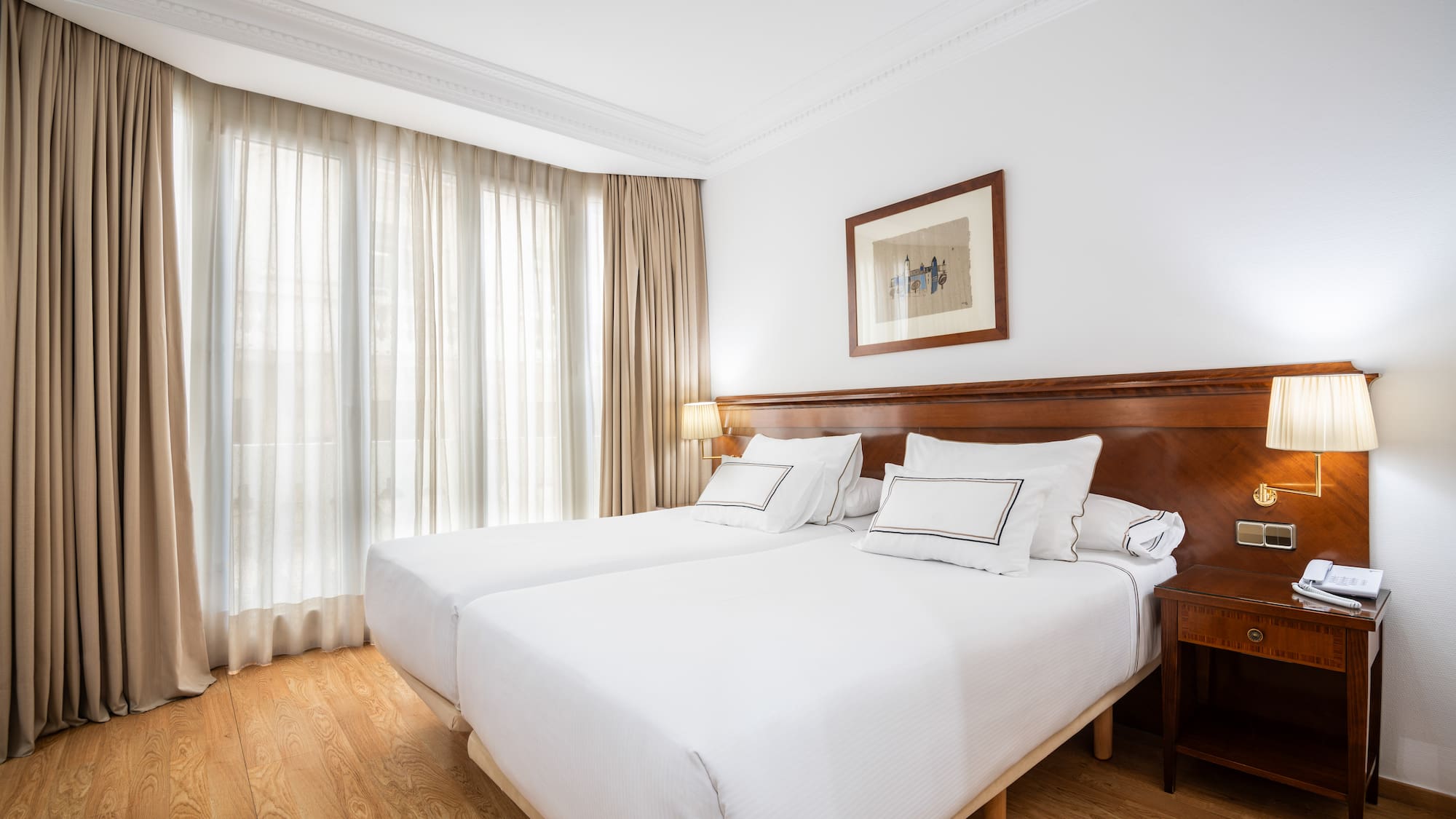 a room with two beds and a lamp