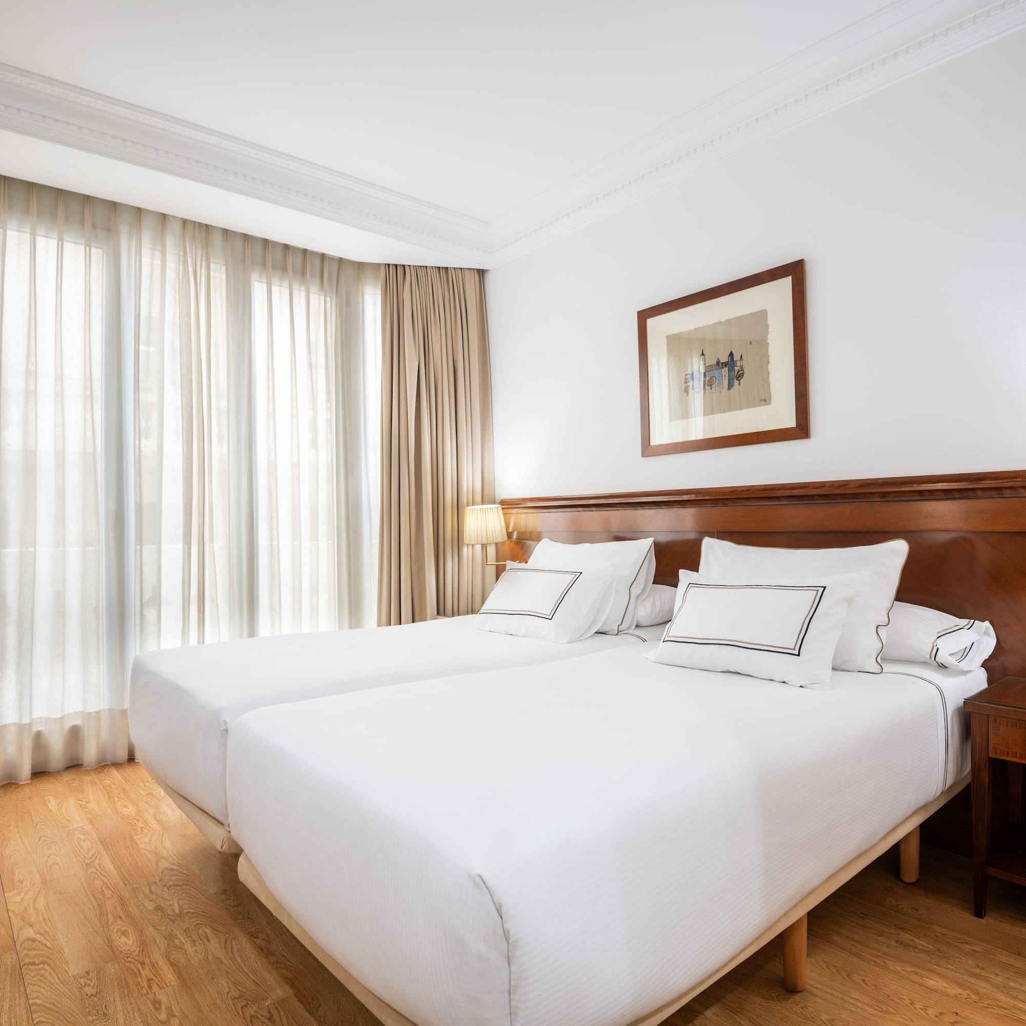 a room with two beds and a lamp