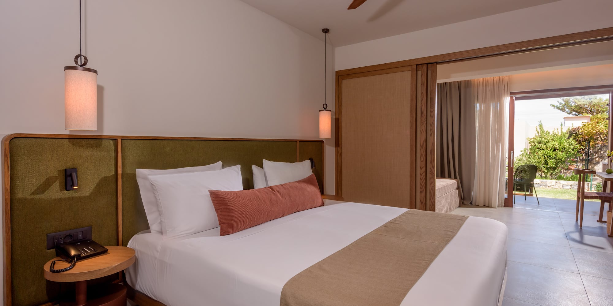 a bed with a fan and a ceiling fan