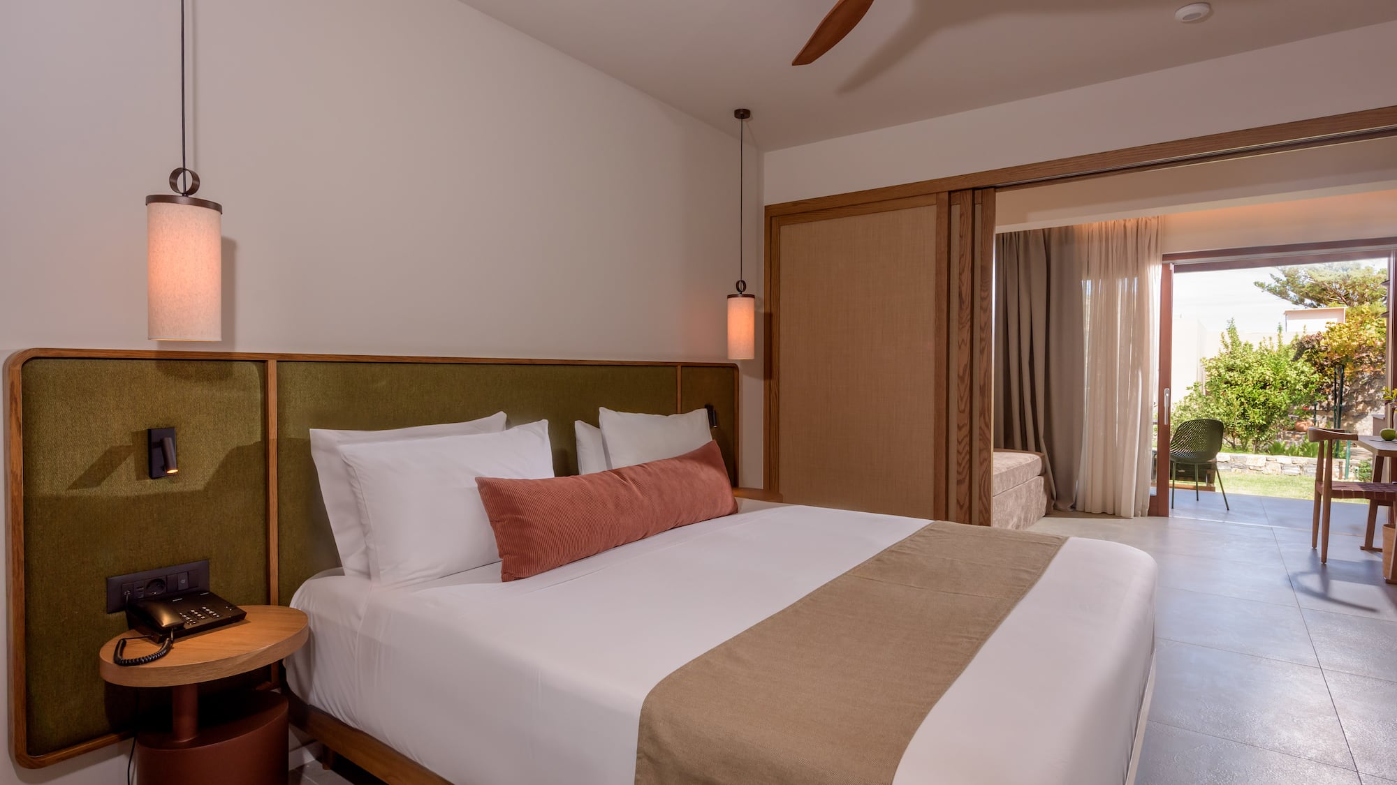 a bed with a fan and a ceiling fan