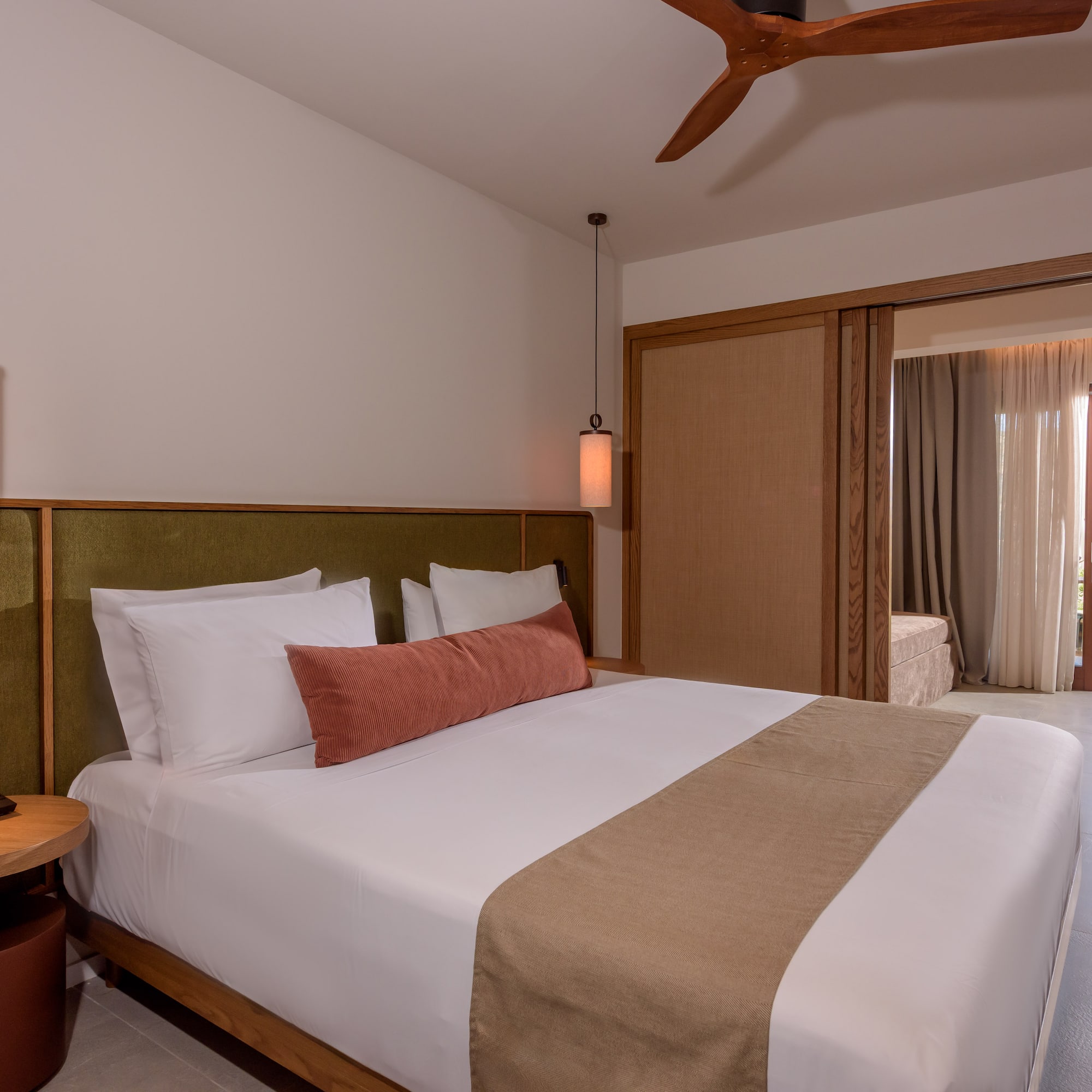 a bed with a fan and a ceiling fan