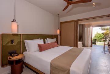a bed with a fan and a ceiling fan
