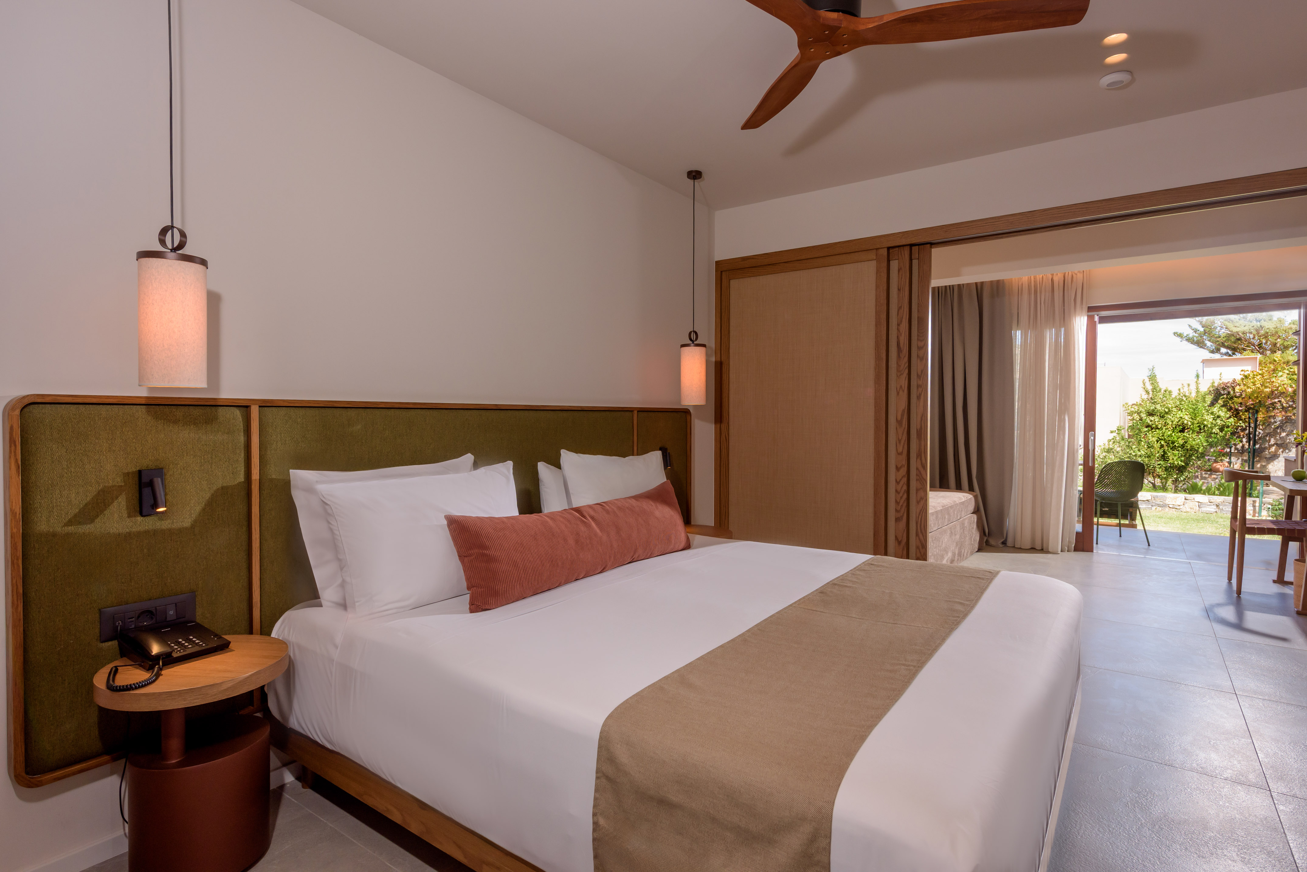 a bed with a fan and a ceiling fan