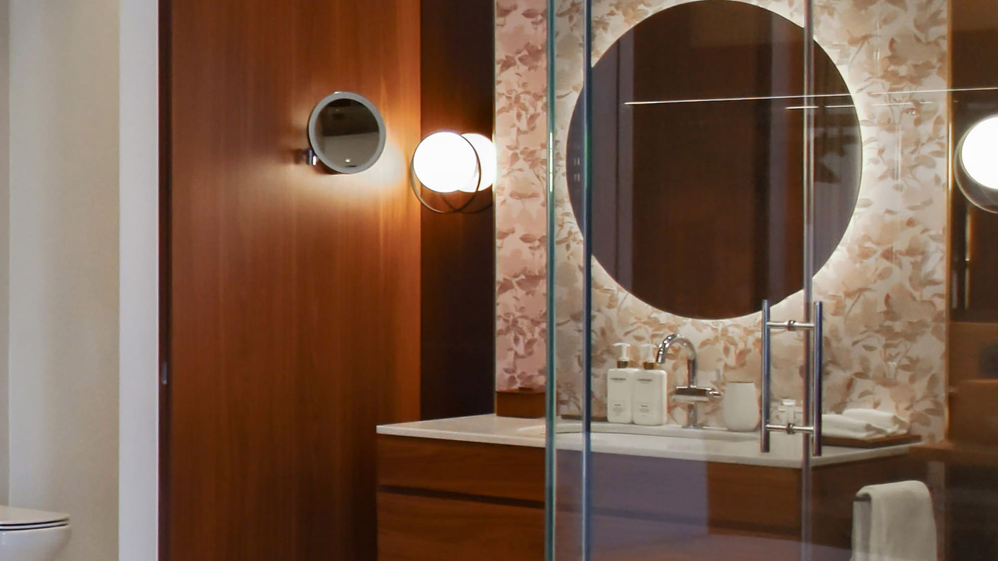 a bathroom with a glass shower door