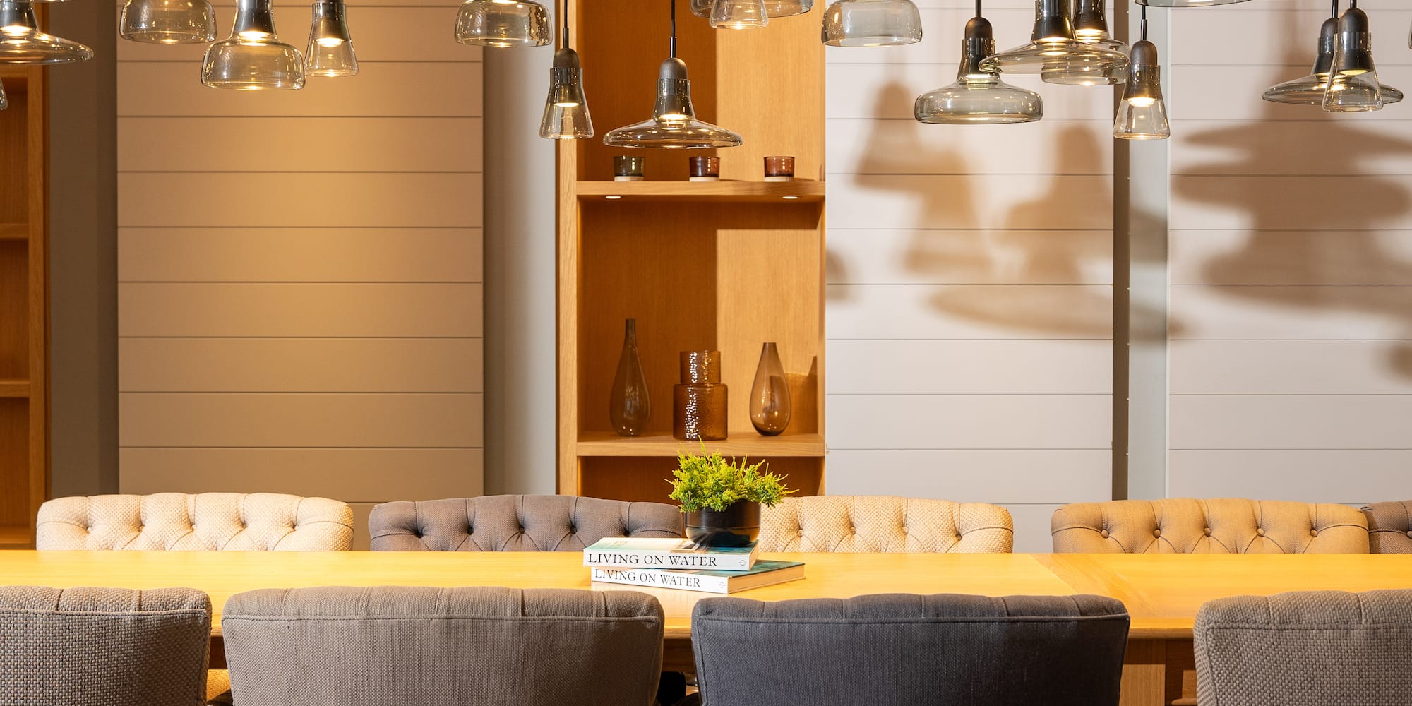 a dining table with chairs and a book on it