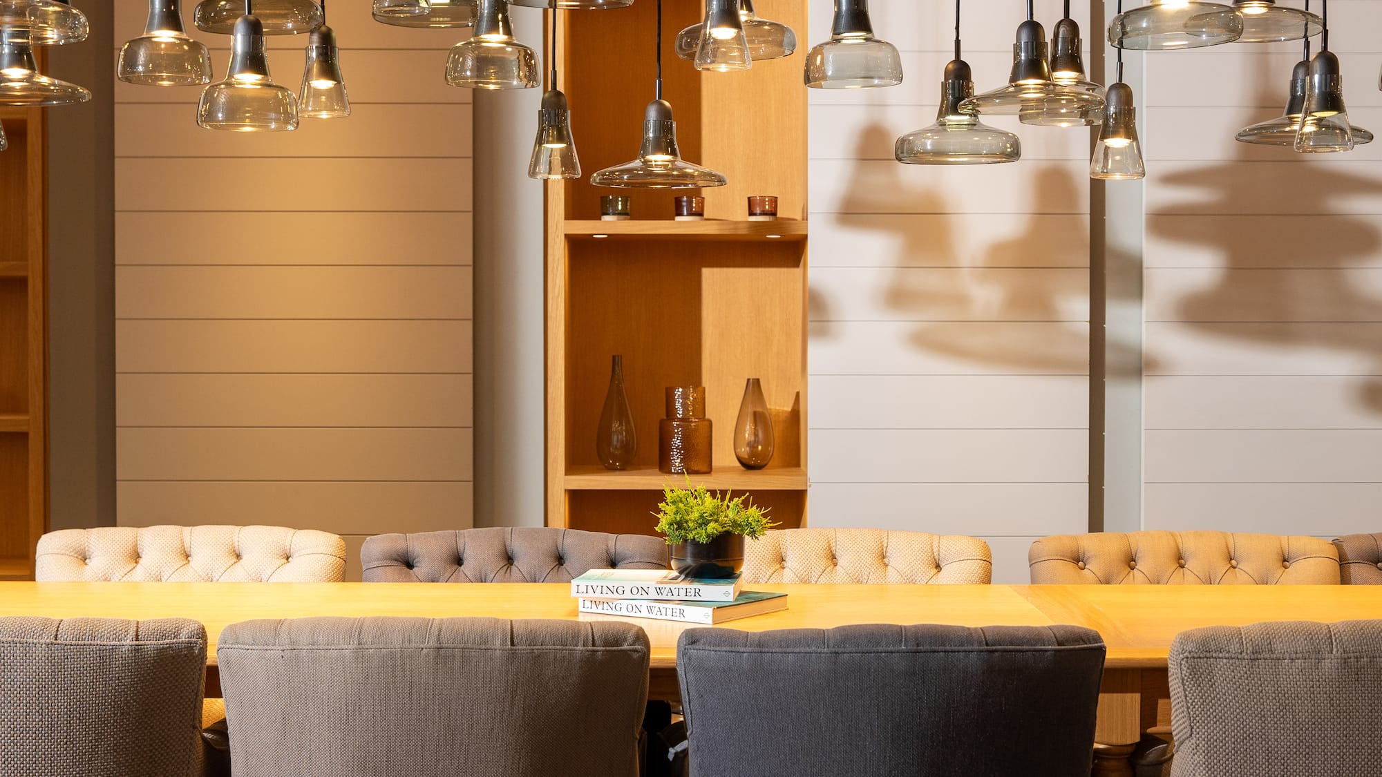 a dining table with chairs and a book on it