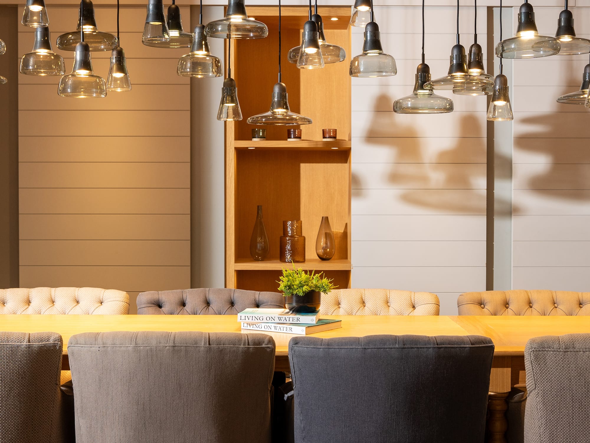 a dining table with chairs and a book on it