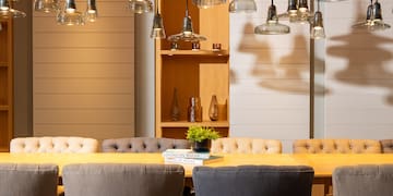 a dining table with chairs and a book on it