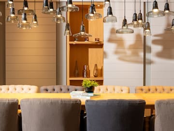 a dining table with chairs and a book on it